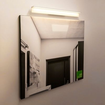 LED-seinävalaisin valaisee neliömäistä peiliä, heijastavaa käytävää ovella ja abstraktia taidetta. Moderni valaistussuunnittelu tyylikkäisiin sisätiloihin.
