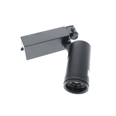 Moderni musta kiskovalaisin, jossa on lieriömäinen lamppu suorakaiteen muotoisella pohjalla, vinosti valkoista taustaa vasten kulmassa tyylikkään valaistusratkaisun saavuttamiseksi.