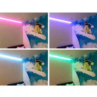 Lumilautailijan seinämaalaus seinällä vaaleanpunaisella, violetilla, sinisellä ja vihreällä LED-valoilla, jotka korostavat huoneen nurkkaa. Täydellisen tunnelman luovat monipuoliset LED-valaistusvaihtoehdot.