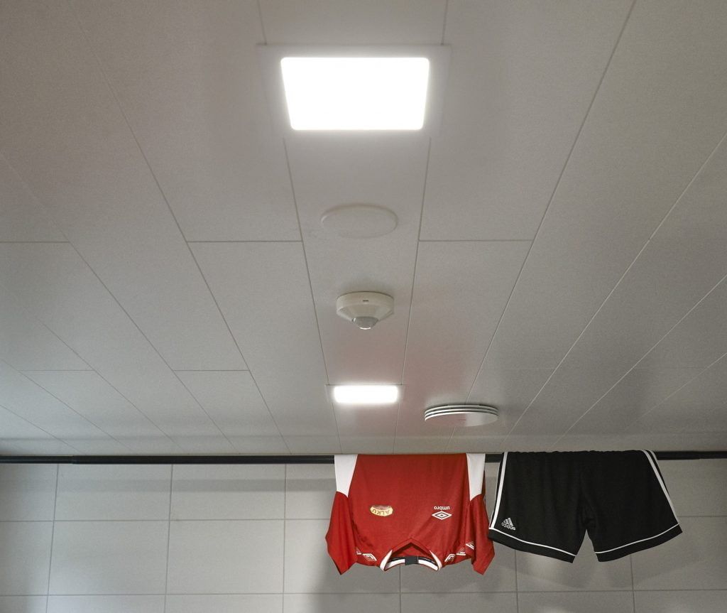 Vihreä tausta, jonka keskellä on valkoinen neliöääriviiva, jonka sisällä on teksti "LED STORE", joka korostaa energiatehokkaita valaistusratkaisuja.